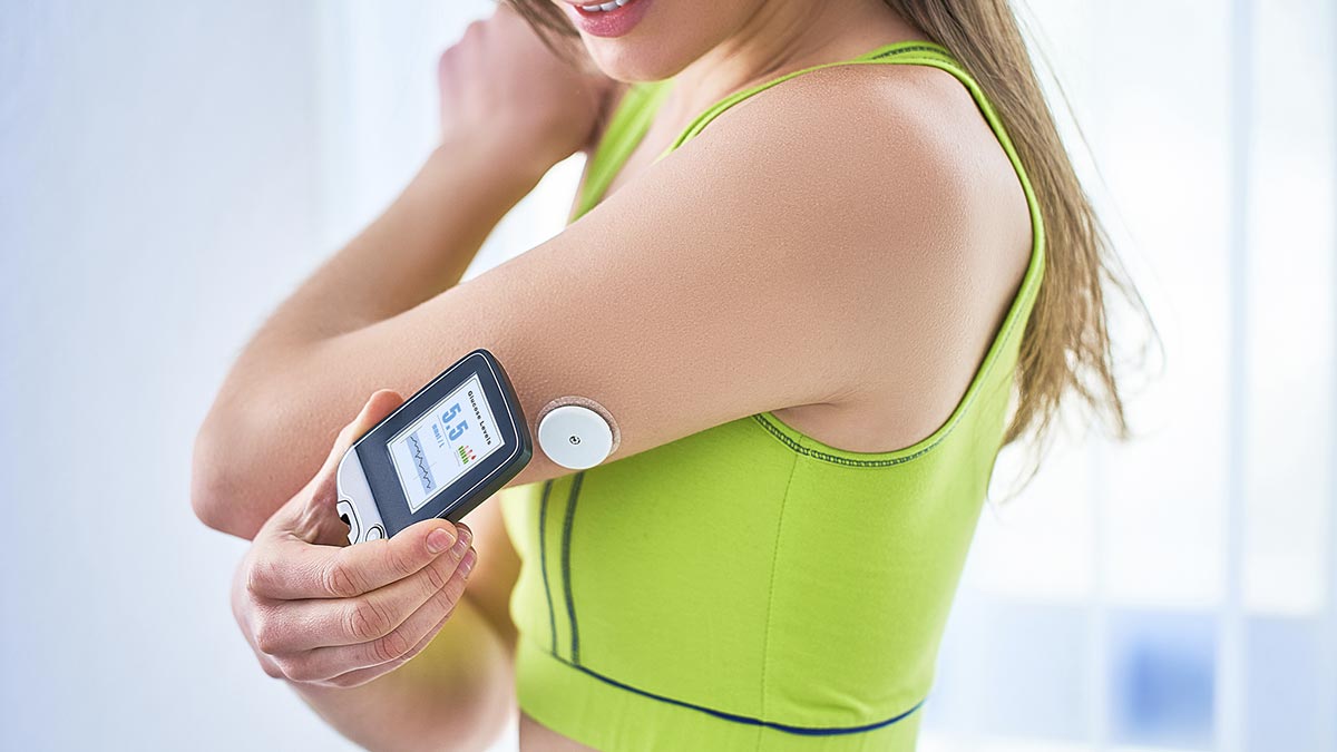 Mulheres diabéticas controlam e verificam o nível de glicose com um sensor remoto