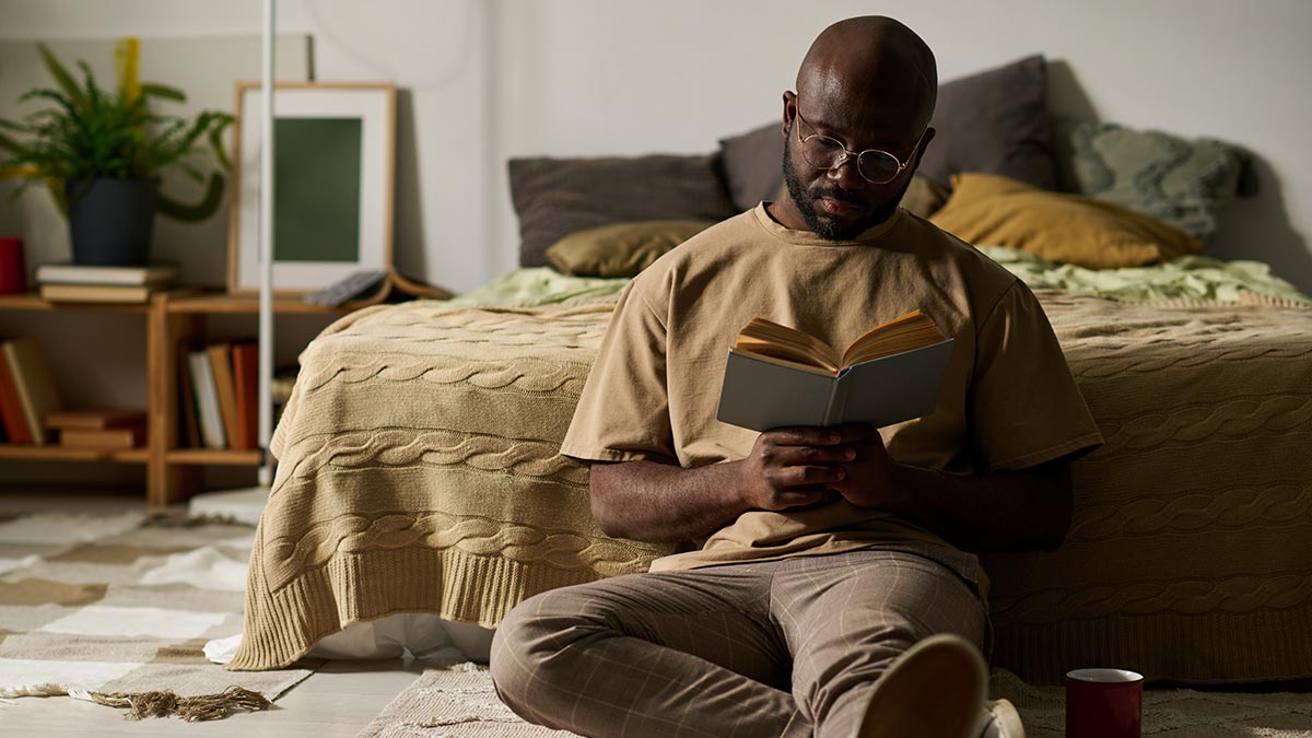 Homem lendo livro em seu momento pós trabalho